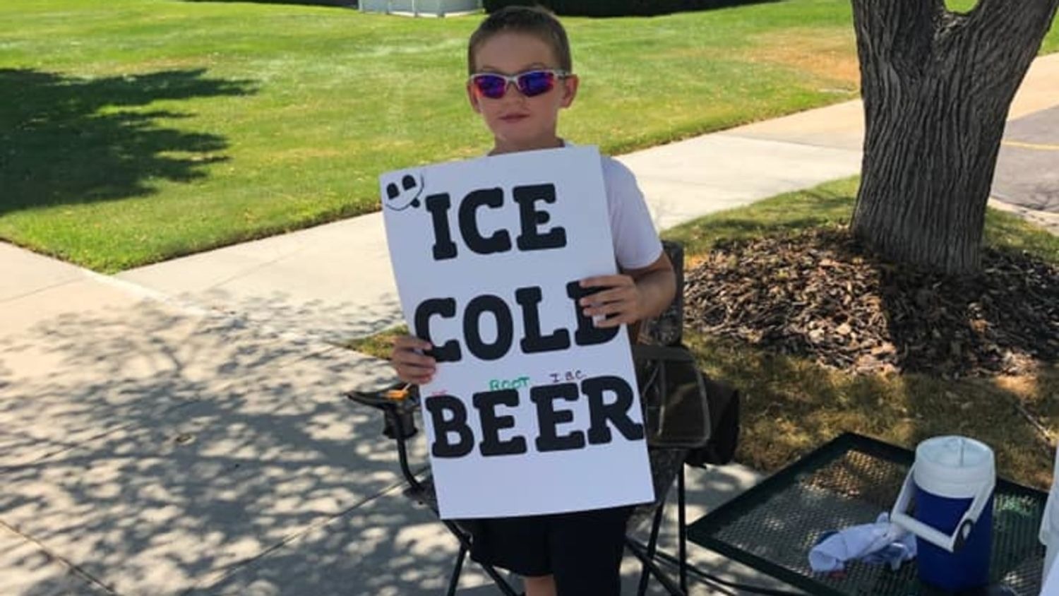 Cops Called On Boy Selling ‘Ice Cold Beer’, Burst Out Laughing When They Look Closer At Sign